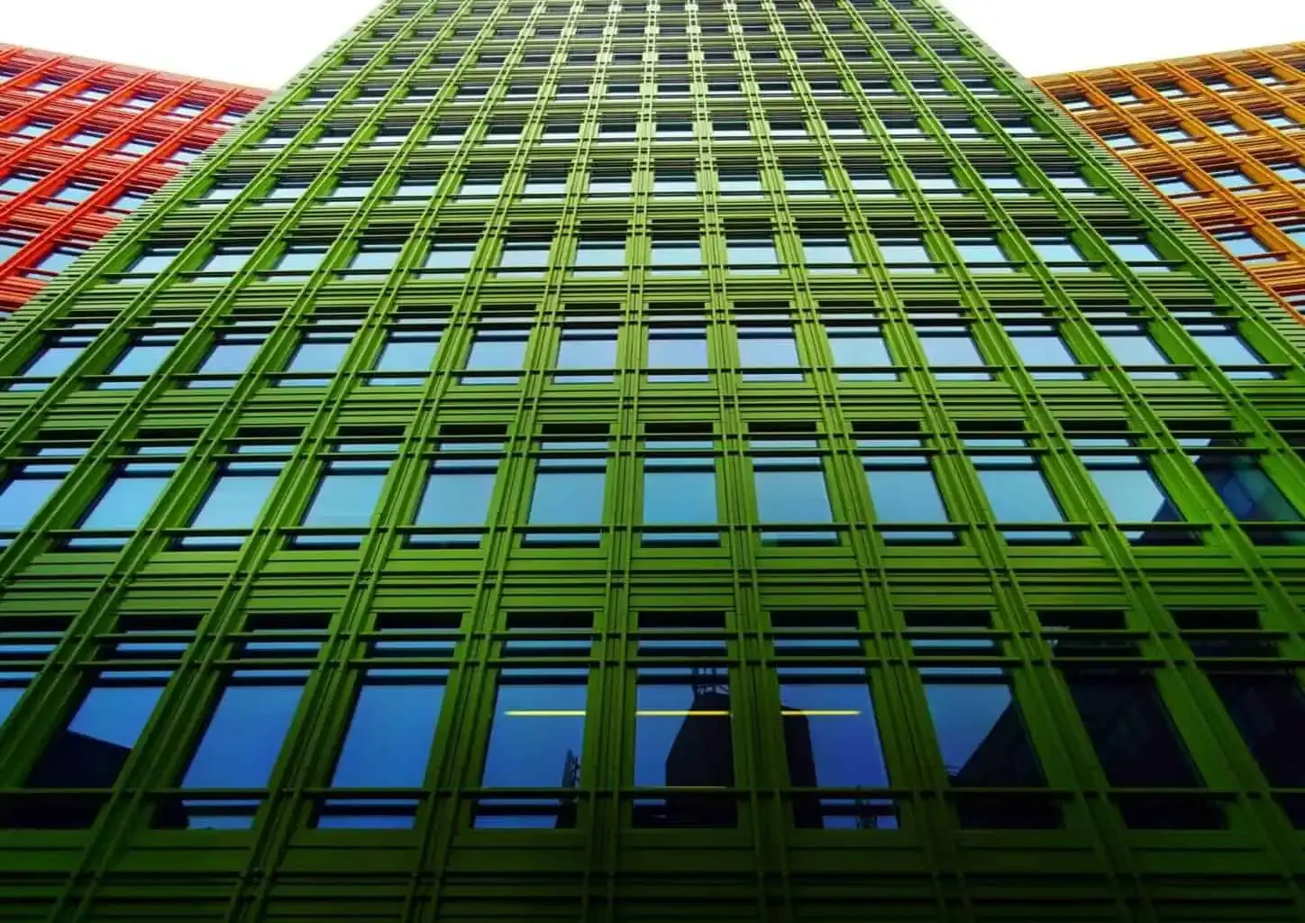 Colorful modern building facade with green and red.