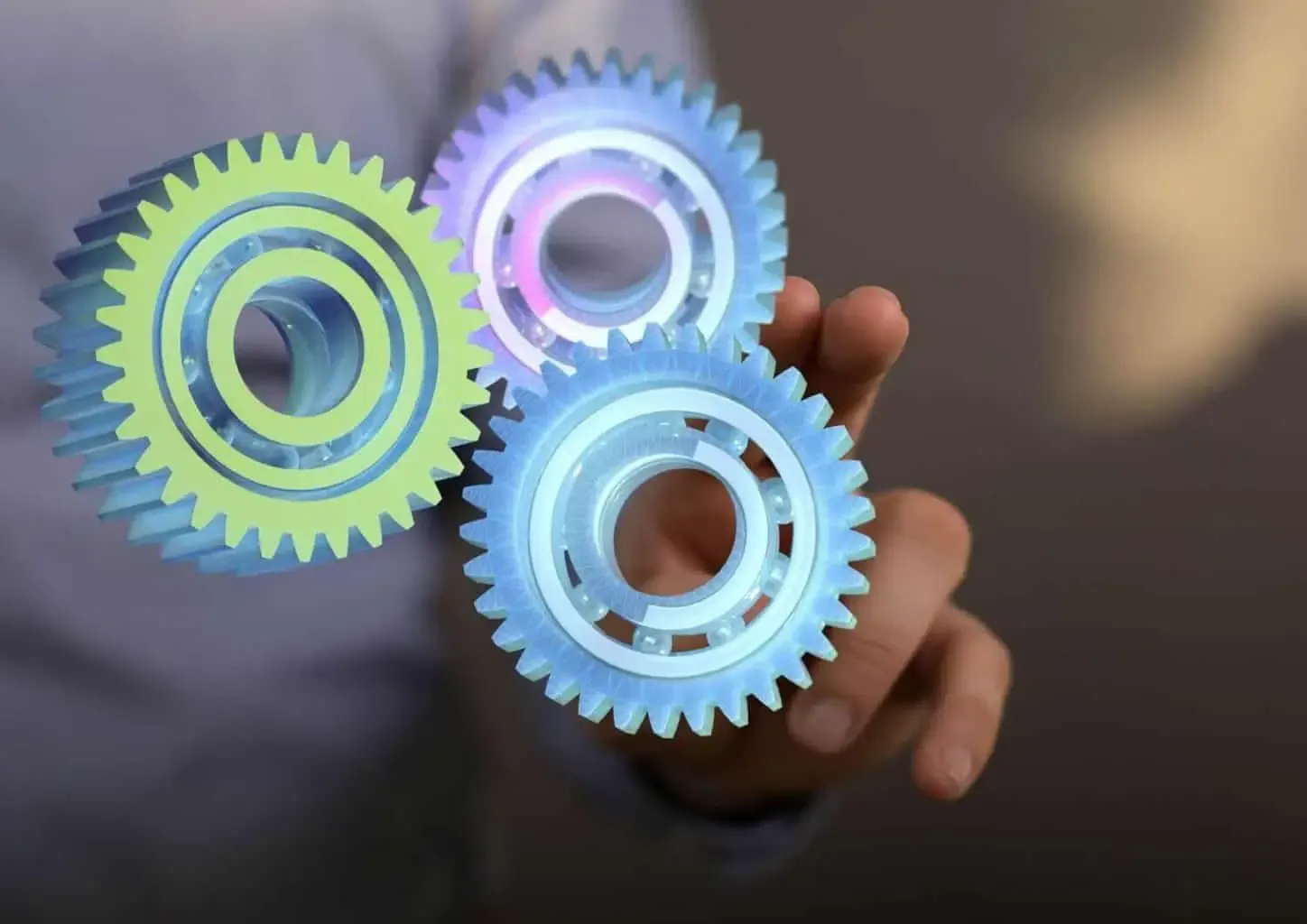 Person holding transparent mechanical gears