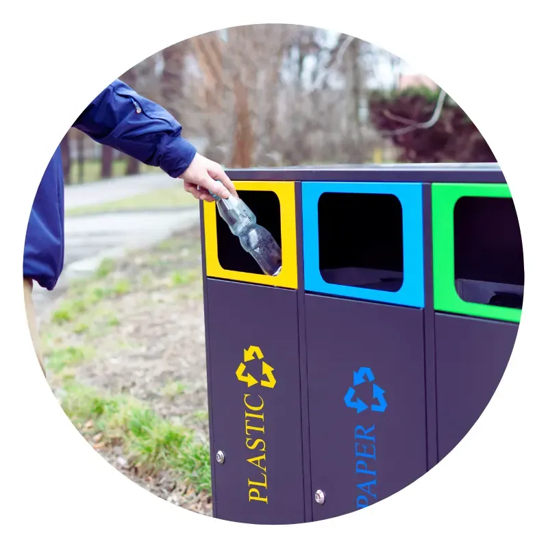Recycling plastic bottle into bin outdoors.